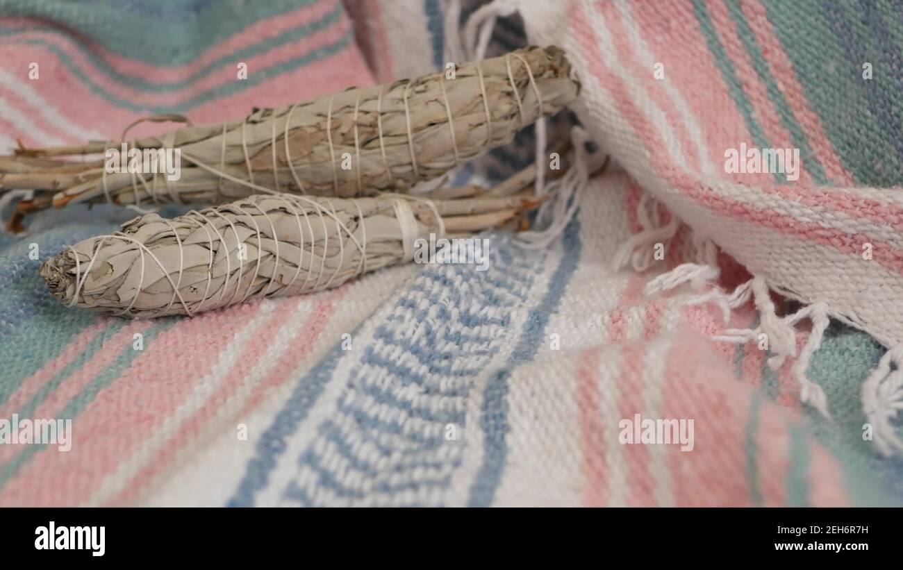 Dried white sage smudge stick, relaxation and aromatherapy. Smudging during psychic occult ceremony, herbal healing, yoga or aura cleaning. Essential Stock Photo