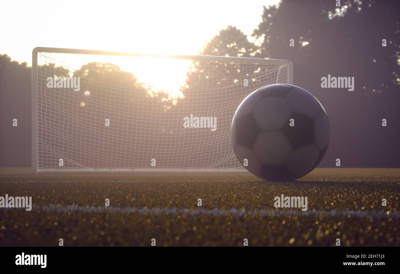 Soccer ball on the field with the sunset in the background. Depth of field with focus on the ball. Stock Photo