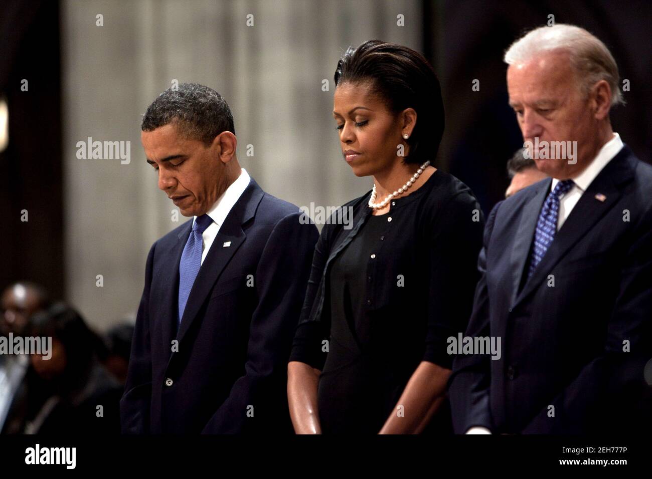 President Barack Obama, First Lady Michelle Obama, and Vice President Joe  Biden bow their heads during the funeral for Dorothy Height at Washington  National Cathedral in Washington, D.C., April 29, 2010 Stock