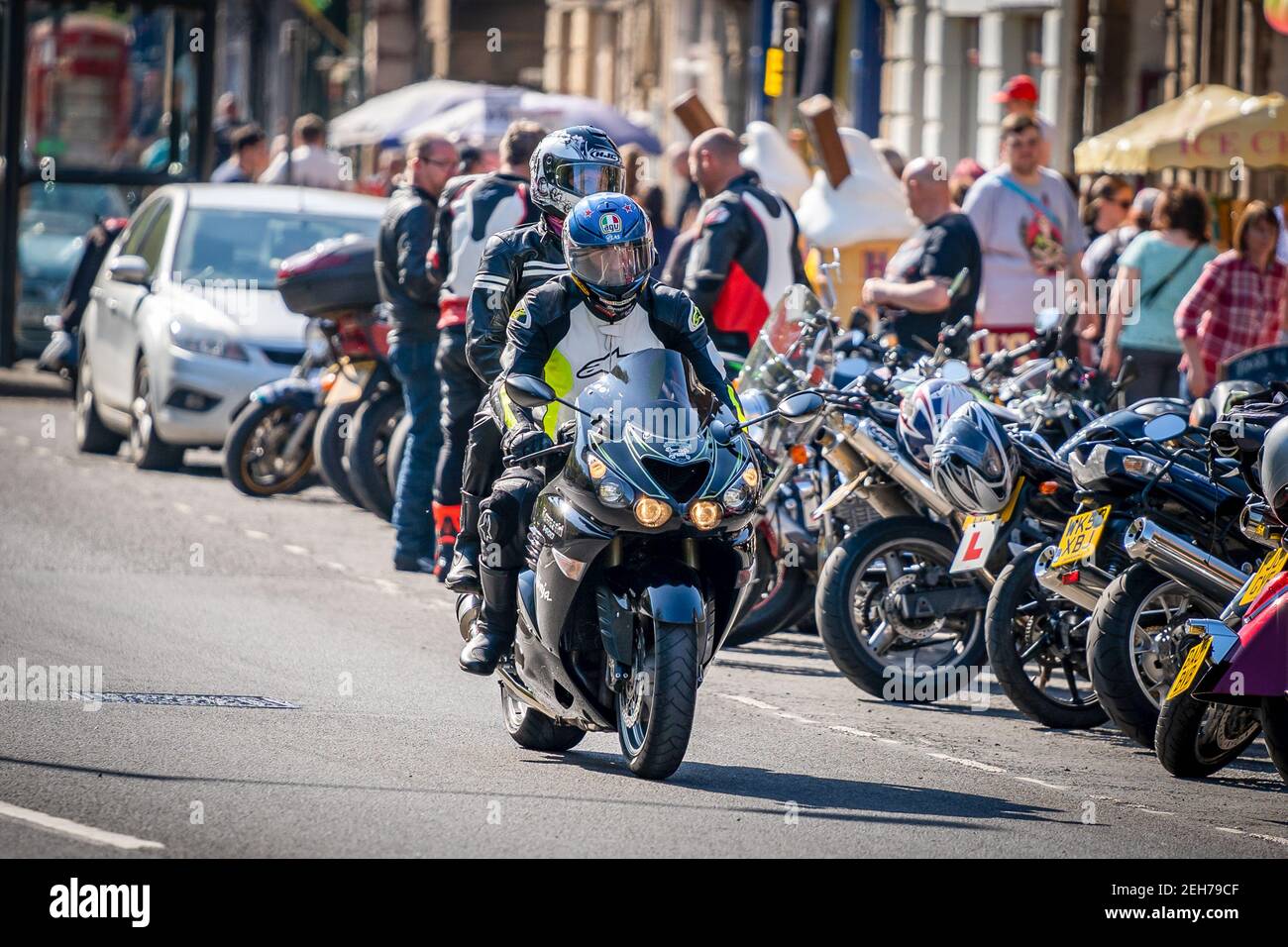 Matlock busy packed town centre full famous for lots of motorbikes and motorcyclists all wearing helmets enjoying sunshine riding road Peak District Stock Photo