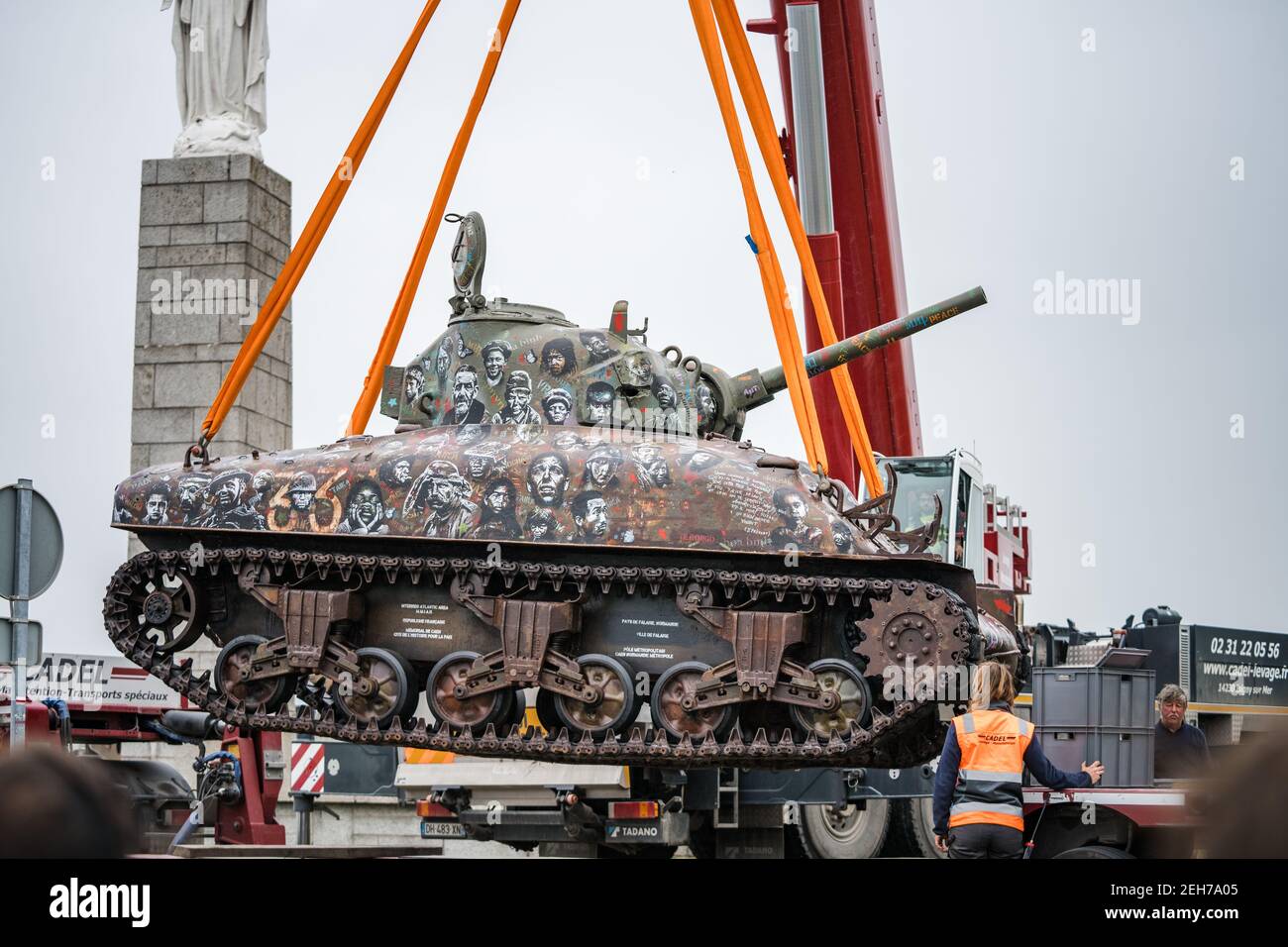 World War 2 Sherman M4 Tank monument memorial being delivered and lifted by crane Arromanches Gold Beach Omaha for the 75th D-Day landing Normandy Stock Photo