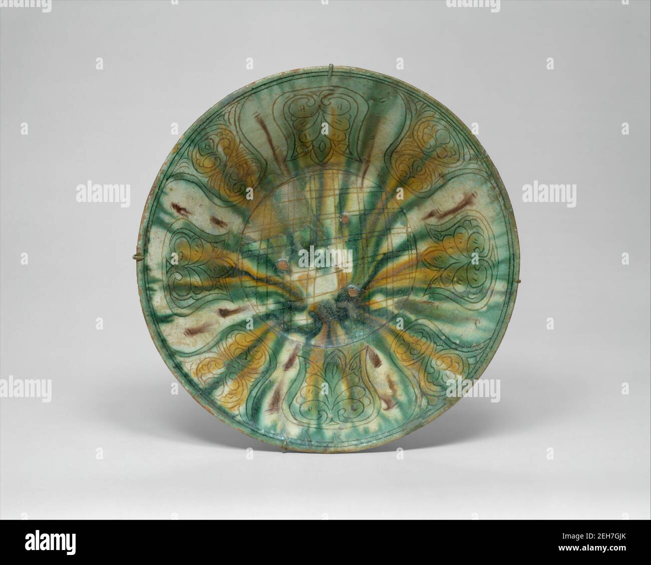 Bowl with Green, Yellow, and Brown Splashed Decoration, Iran, 10th century. Stock Photo