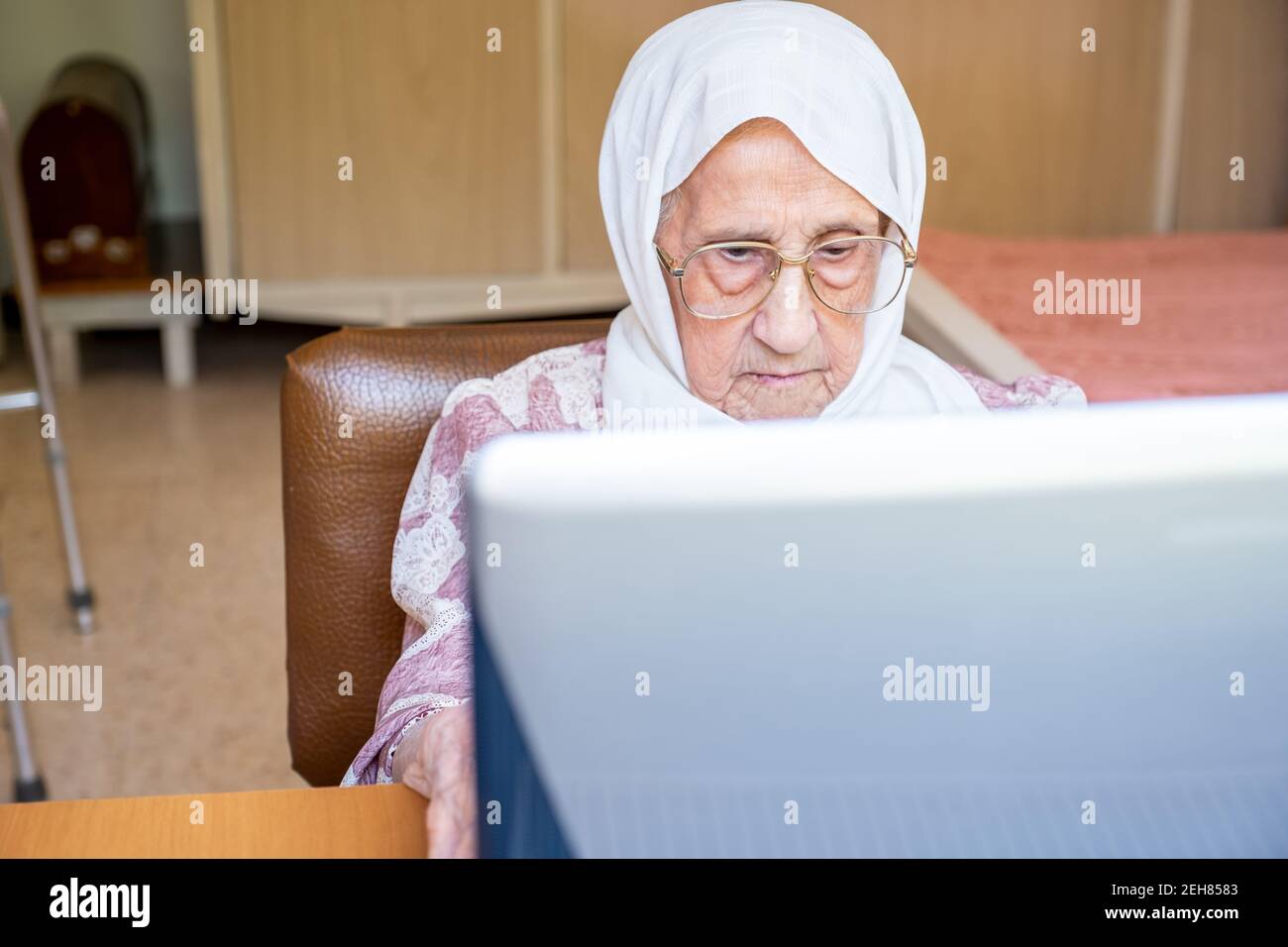 Old woman using laptop for working and communicating Stock Photo