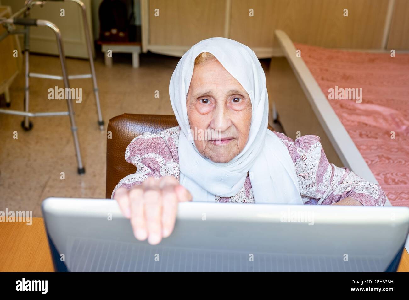 Old woman using laptop for working and communicating Stock Photo