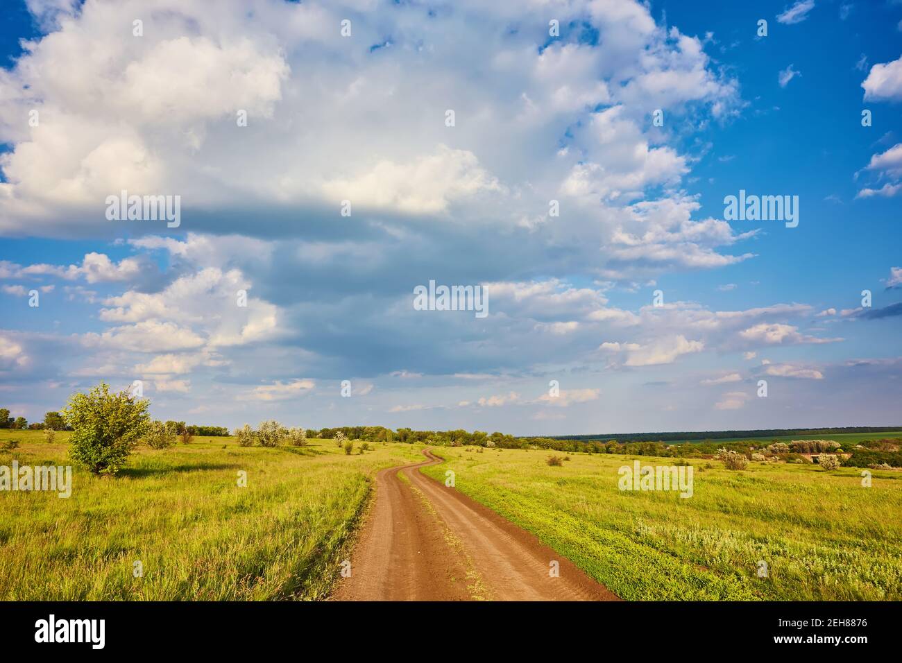 Summer landscape with green grass, road and clouds Stock Photo - Alamy