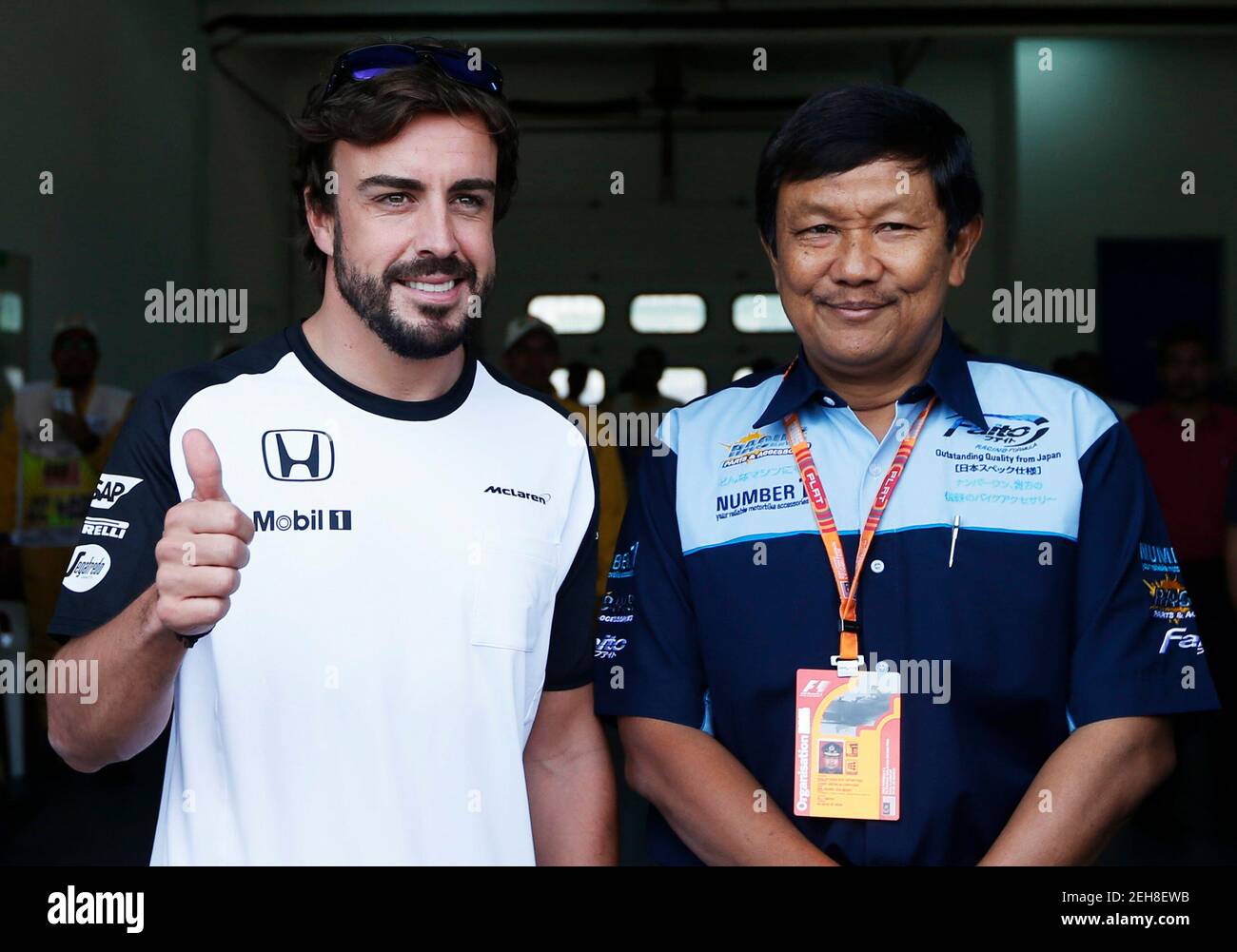 Formula One - F1 - Malaysian Grand Prix 2015 - Sepang International Circuit, Kuala Lumpur, Malaysia - 26/3/15  McLaren's Fernando Alonso (L) gestures while leaving the medical  centre  Reuters / Olivia Harris  Livepic Stock Photo