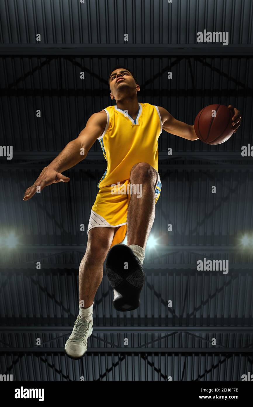 Young professional basketball player in action, motion isolated on black  background, look from the bottom. Concept of sport, movement, energy and  dynamic, healthy lifestyle. Training, practicing Stock Photo - Alamy