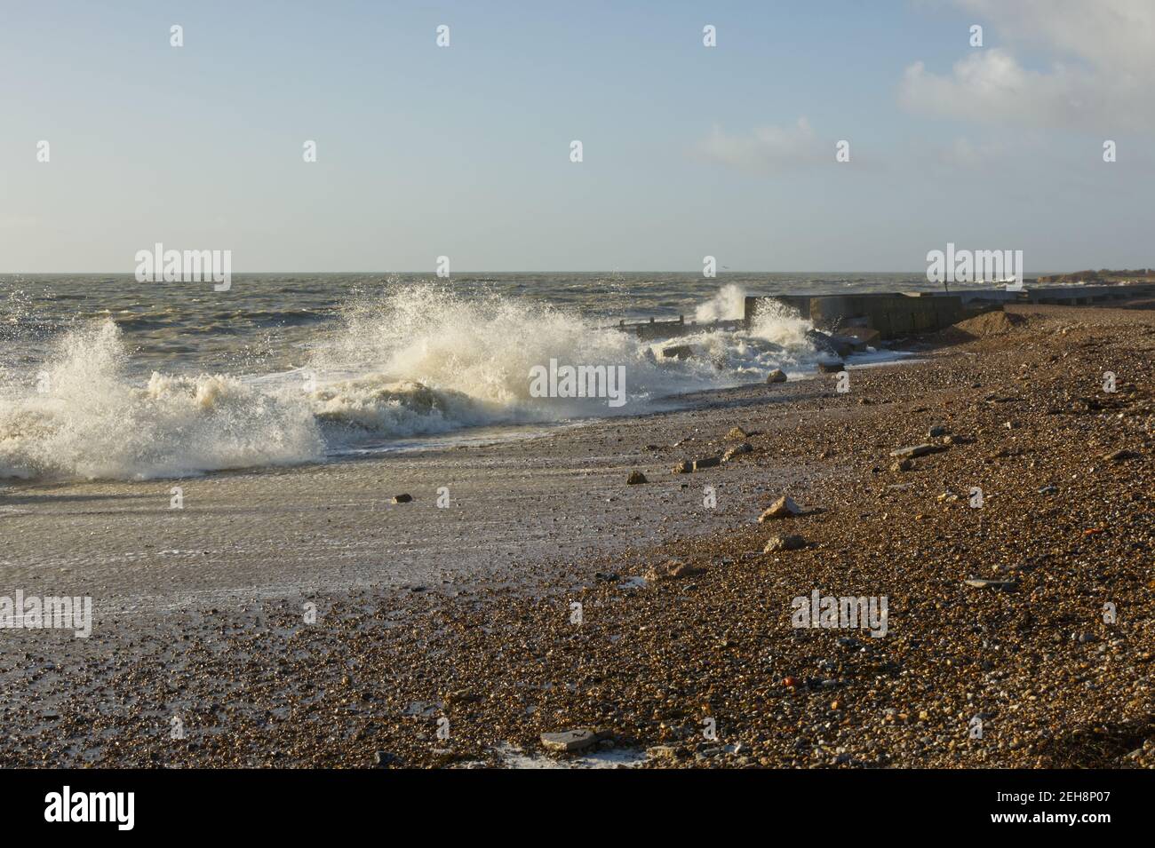 Stormy weather with waves on shingle beach at Climping near Littlehampton, West Sussex, England. Storm damage to coastal defences. Stock Photo