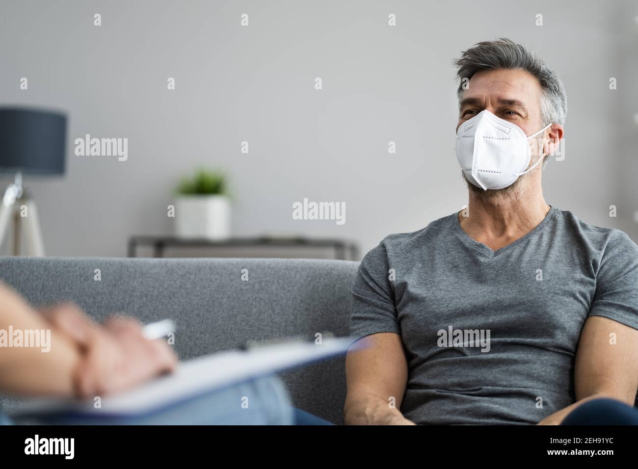 Psychiatrist Or Psychology Psychologist With Clipboard And Face Mask Stock Photo