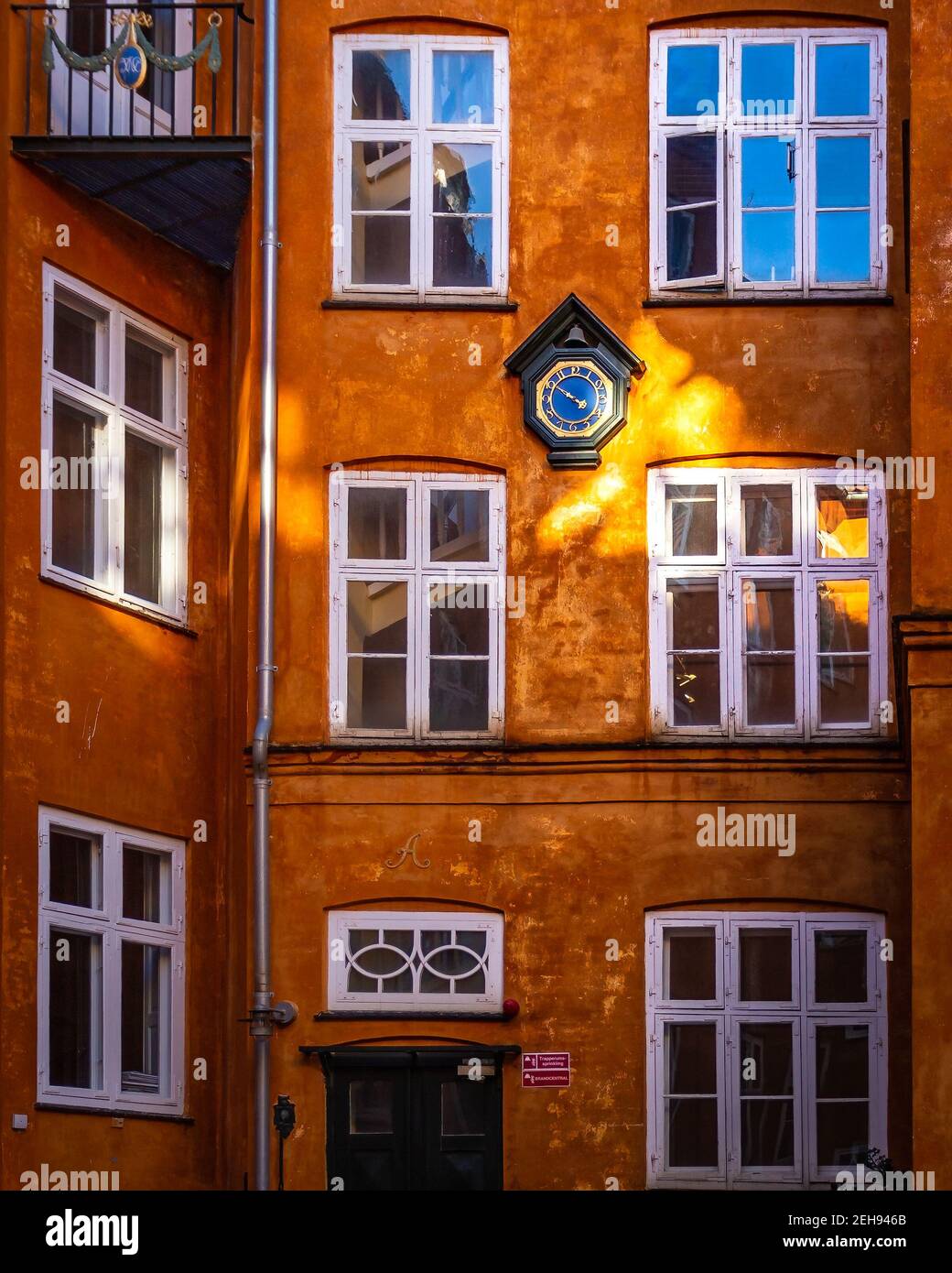 Beautiful old backyard in central Copenhagen with sunlight kissing the building. Stock Photo