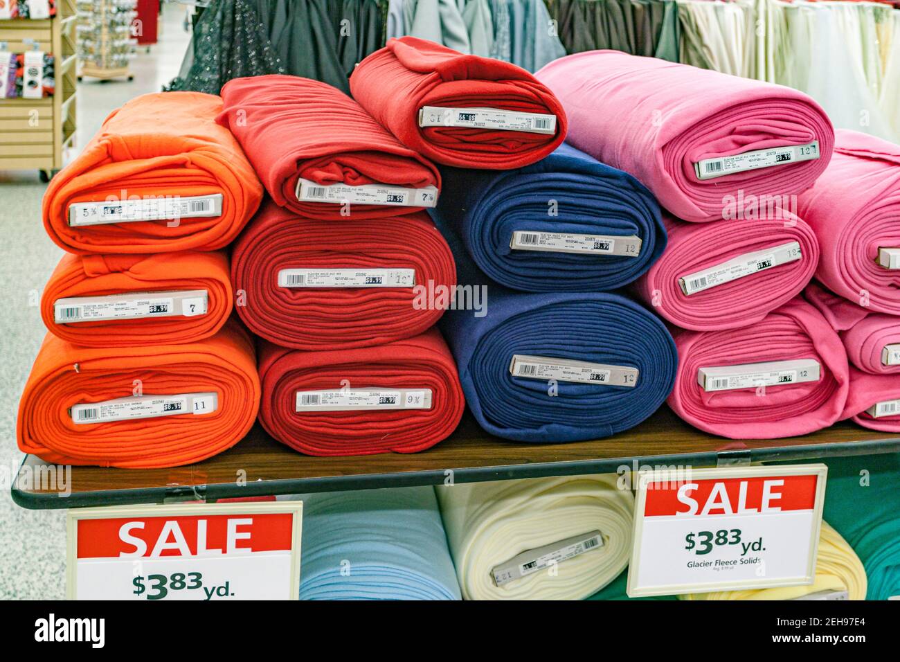 Colorful bolts of fleece fabric on sale in a retail store. Stock Photo