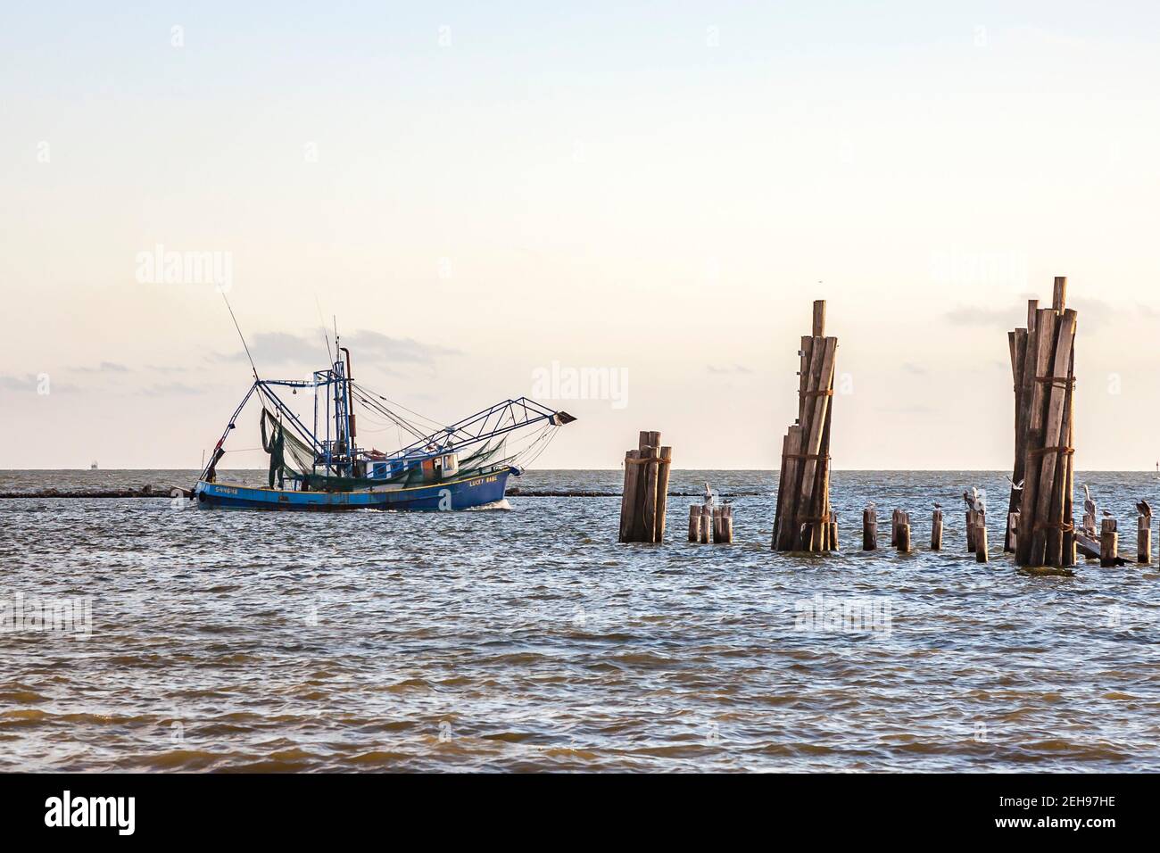Commercial shrimp boat Lucky Babe heading out to the Gulf of Mexico at Biloxi Mississippi Stock Photo