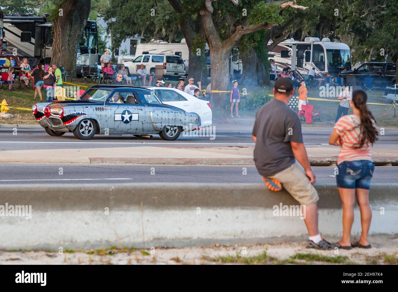 Spectators watch a stream of Classic cars along Highway 90 on the Mississippi Gulf Coast during the annual Cruisin' the Coast event. Stock Photo