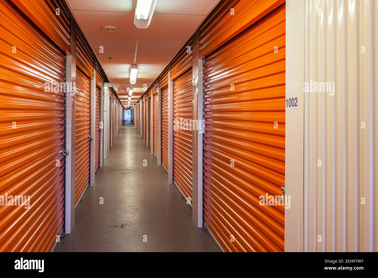 Orange interior of self storage units at an enclosed mini warehouse facility Stock Photo