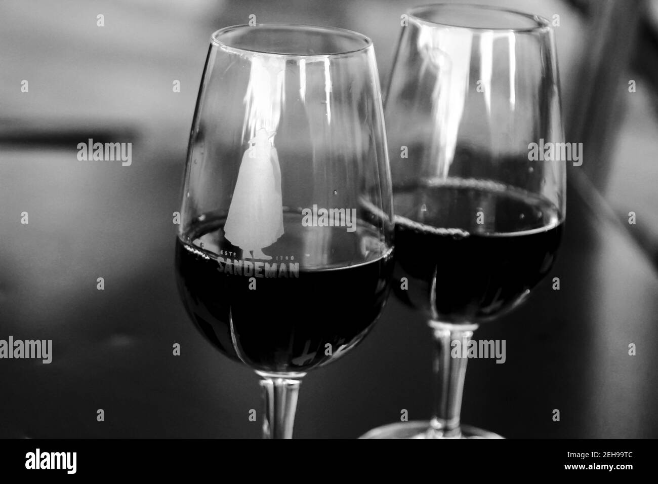 Porto, Portugal- December 30, 2019: Two glasses of tasty port wine tawny Sandeman brand on a table in a cafe in Porto Stock Photo