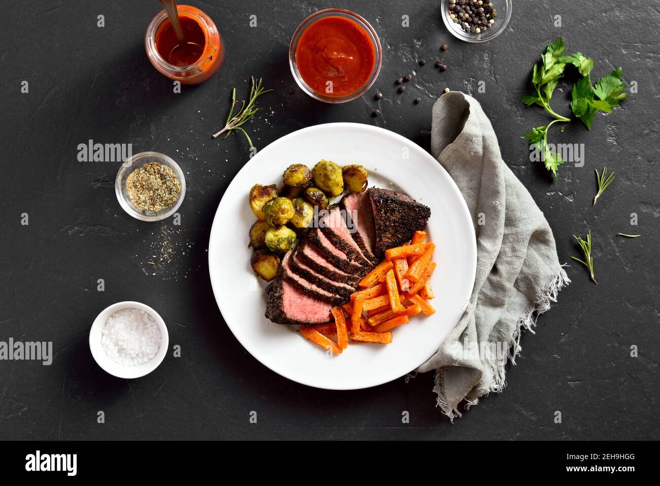 Grilled beef steak with brussels sprouts and sweet potatoes on plate