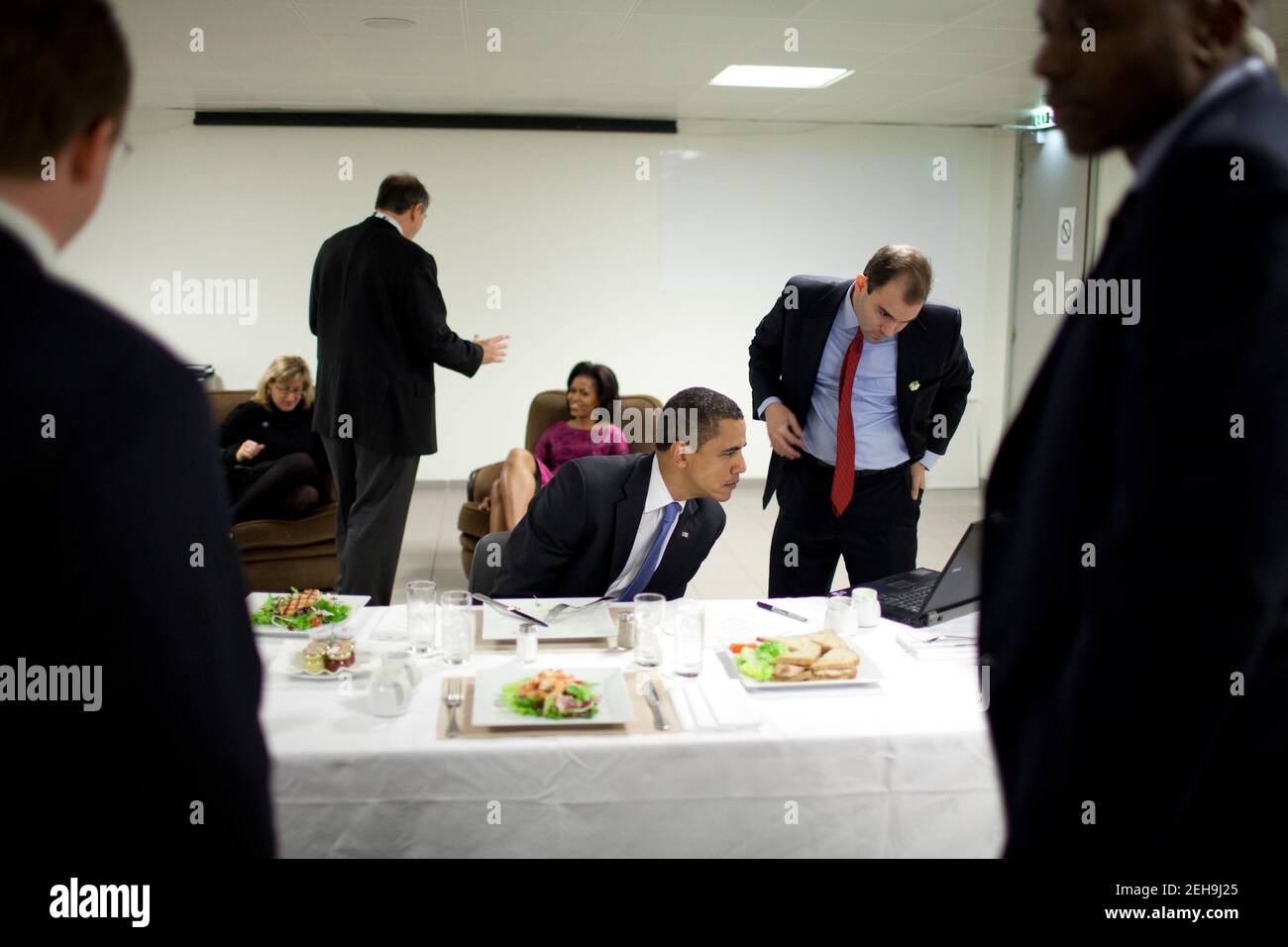 President Barack Obama reviews his speech to the Turkish parliament with speechwriter Ben Rhodes while eating lunch April 3, 2009, in Strasbourg, France. Stock Photo