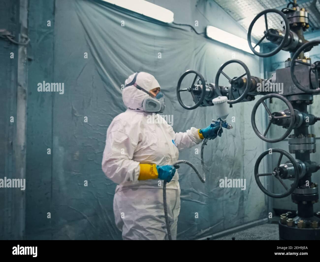 Painting the oil well catches at the plant. spraysprayed Stock Photo