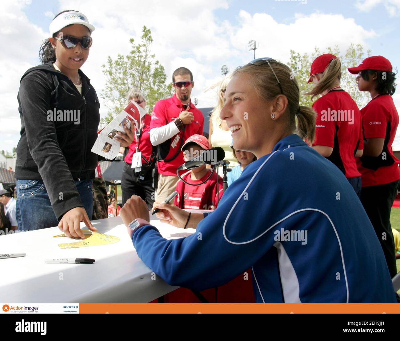 Tennis - Sony Ericsson WTA Tournament - Montreal, Canada - 13/8/06  Mara Santangelo of Italy (R) laughs while signing autographs during the second day at the Rogers Cup, Sony Ericsson WTA Tour  Mandatory Credit: Action Images / Chris Wattie  Livepic Stock Photo