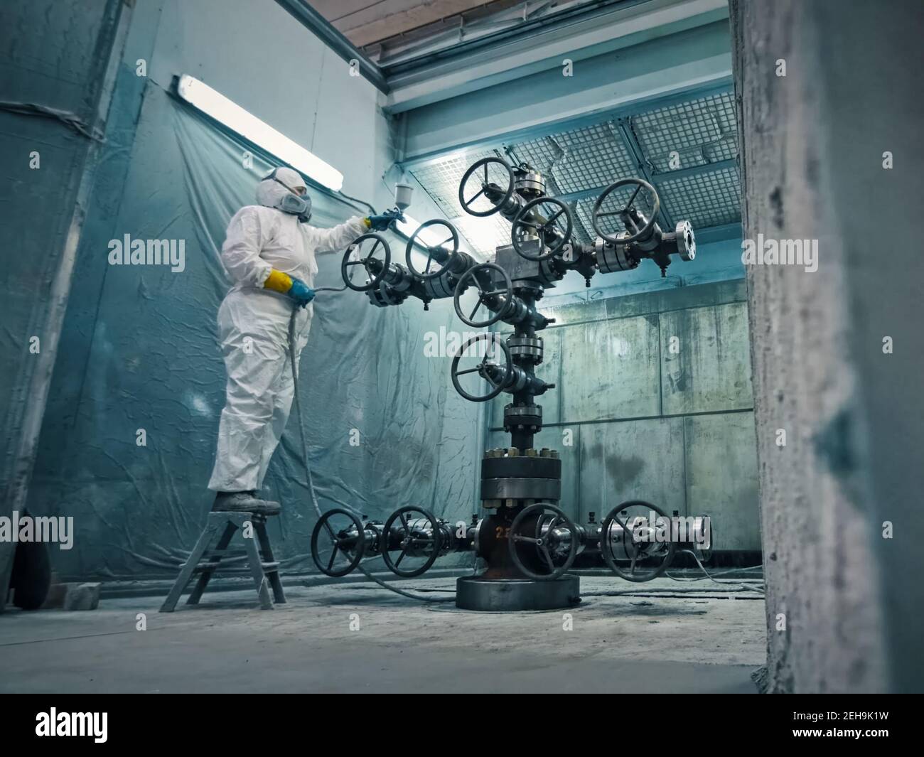 Painting the oil well catches at the plant. spraysprayed Stock Photo