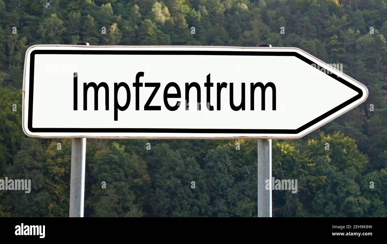 Signpost with the inscription 'Impfzentrum', translation 'Vaccination center' Stock Photo