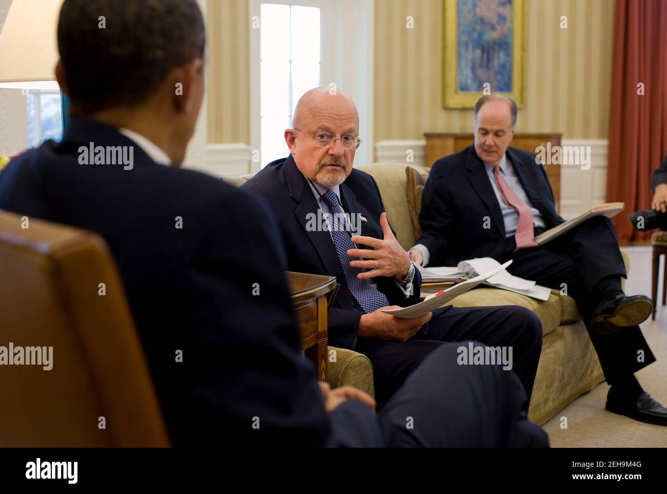 President Barack Obama is briefed on North Korea by Director of National Intelligence James Clapper and National Security Advisor Tom Donilon during the Presidential Daily Briefing in the Oval Office, Nov. 23, 2010. Stock Photo