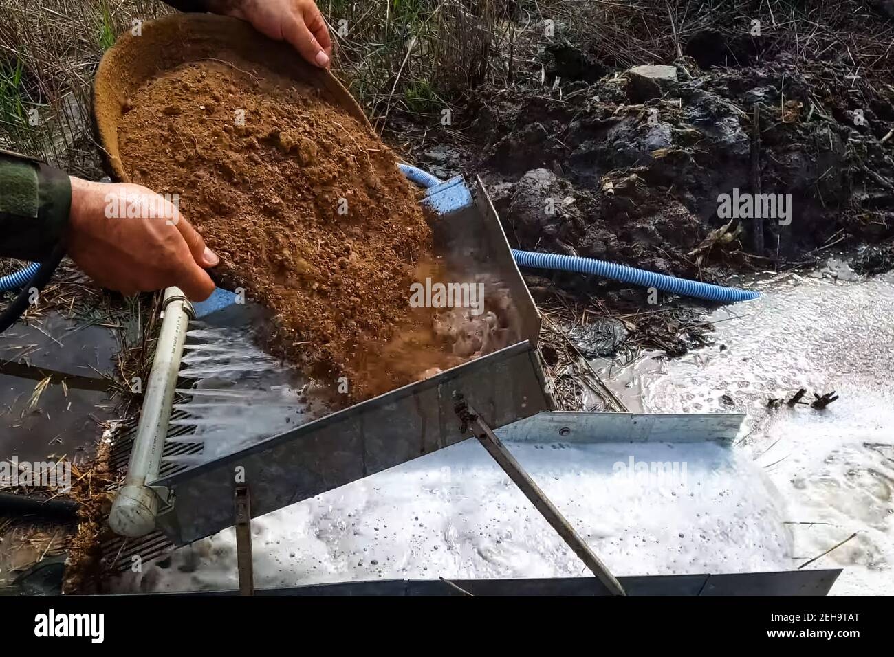 Washing the rock containing gold. Search and extraction of gold Stock Photo Alamy