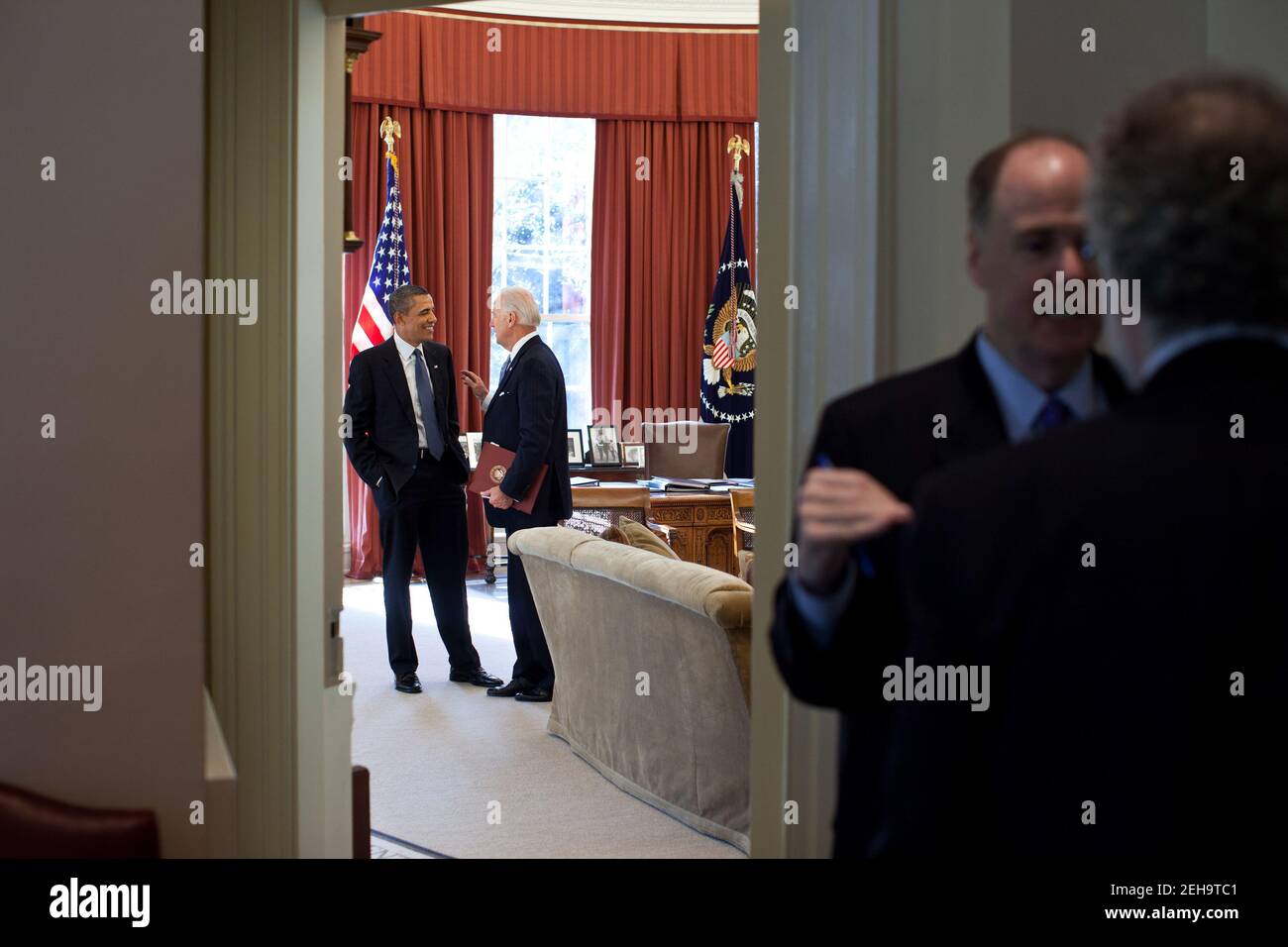 President Barack Obama talks with Vice President Joe Biden in the Oval Office while National Security Advisor Tom Donilon and Counsel to the President Bob Bauer, right, confer in the Outer Oval Office, Jan. 5, 2011. Stock Photo