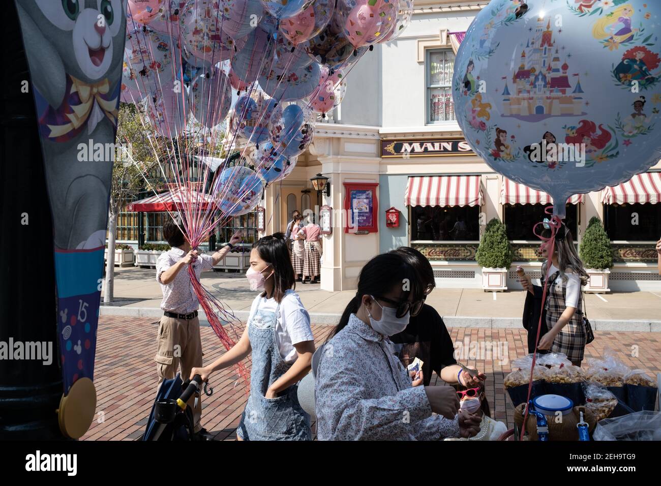 Visitors wearing face masks are seen at Hong Kong Disneyland Park