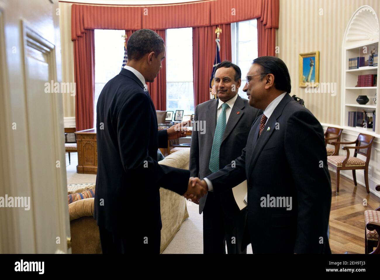 President Barack Obama meets with President Asif Ali Zardari of Pakistan, right, and Husain Haqqani, Pakistan's ambassador to the United States, center, in the Oval Office, Jan. 14, 2011. Stock Photo