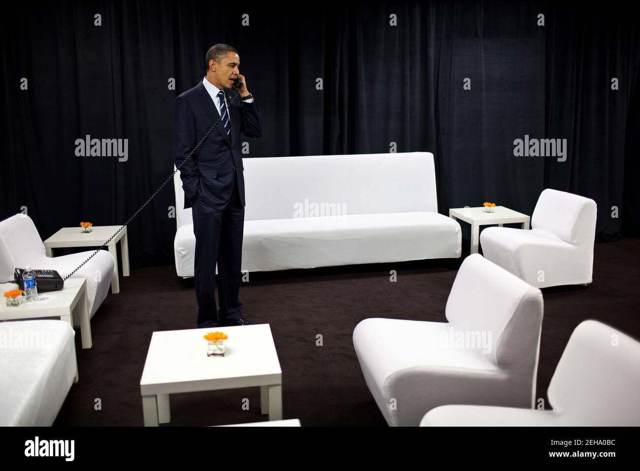 President Barack Obama talks on the phone with National Security Advisor Tom Donilon about developments in the Middle East, while backstage at Intel Corporation in Hillsboro, Ore., Feb. 18, 2011. Stock Photo