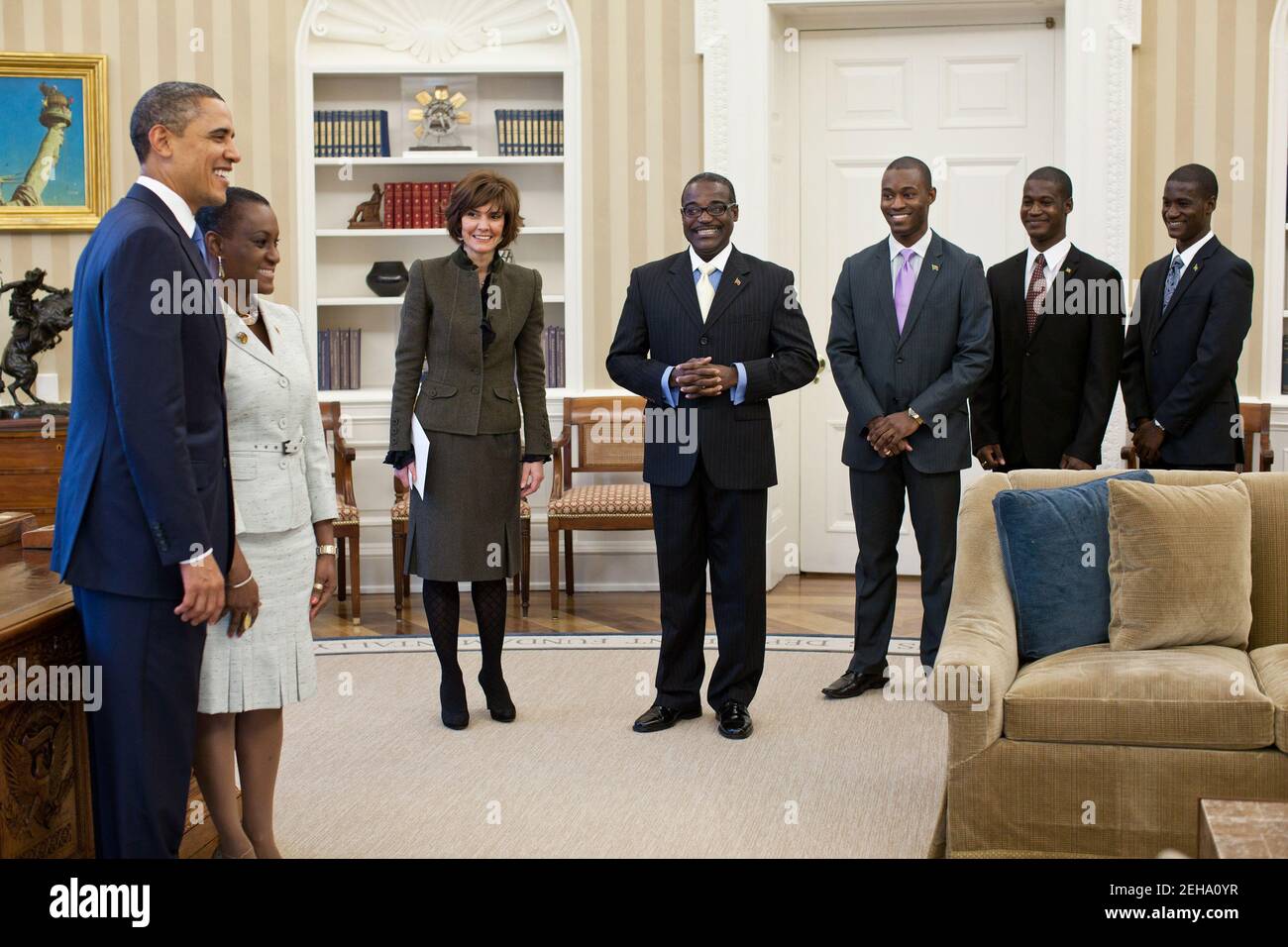 President Barack Obama poses for a photograph with Ambassador Jacinth Lorna Henry-Martin of St. Kitts and Nevis during an ambassador credentialing ceremony in the Oval Office, Feb. 23, 2011. Chief of Protocol Capricia Marshall and members of Henry-Martin's family watch from the edge of the room. Stock Photo