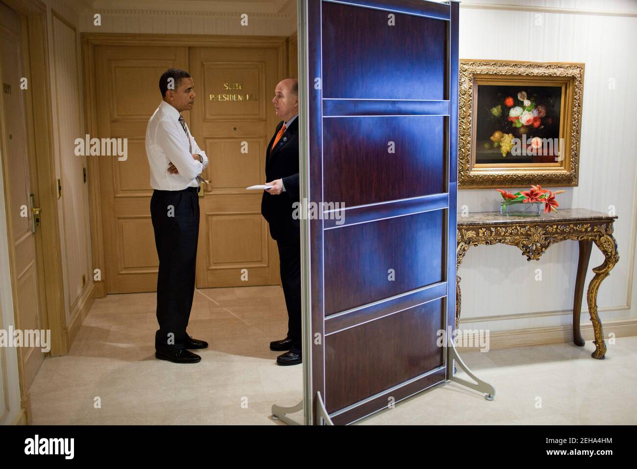 President Barack Obama talks with National Security Advisor Tom Donilon in the hallway outside his hotel suite in Santiago, Chile, March 21, 2011. Stock Photo