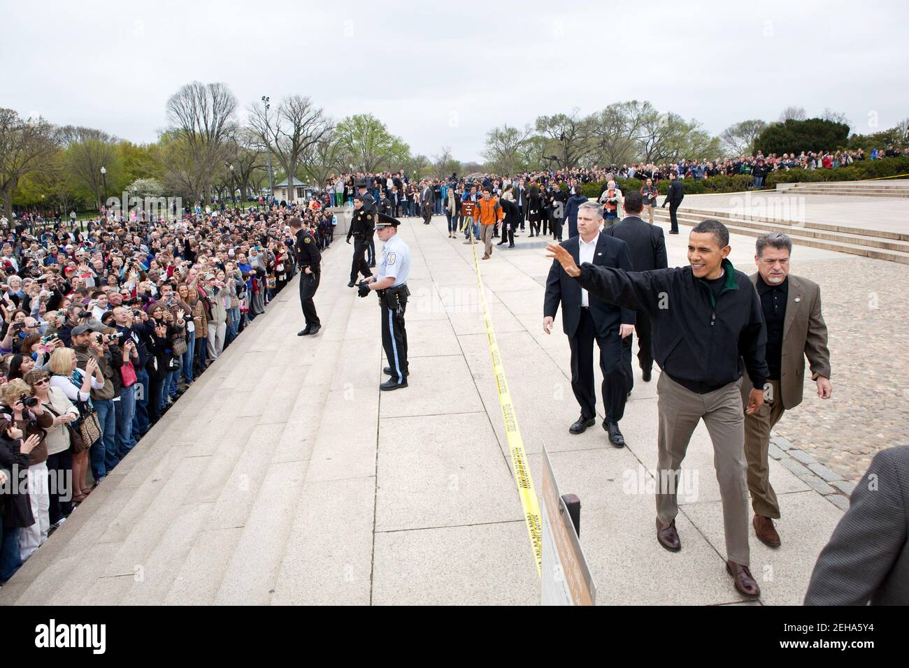 President Barack Obama waves to tourists at the Lincoln Memorial in Washington, D.C., April 9, 2011. The President made an unannounced stop to thank people for visiting the memorial a day after he and Congressional leaders agreed on a bill to keep the government open. Stock Photo