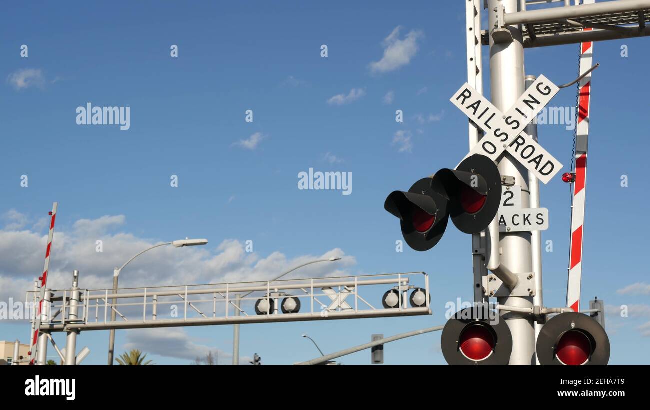 Level crossing warning signal in USA. Crossbuck notice and red traffic