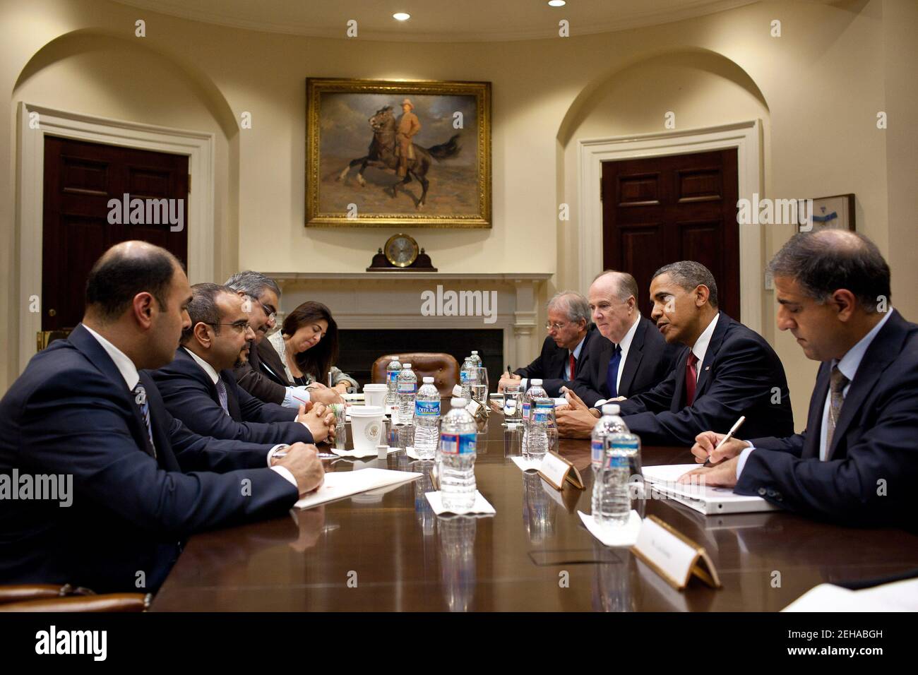 President Barack Obama drops by a meeting between National Security Advisor Tom Donilon and Crown Prince Salman of Bahrain, second from left, in the Roosevelt Room of the White House, June 7, 2011. Stock Photo