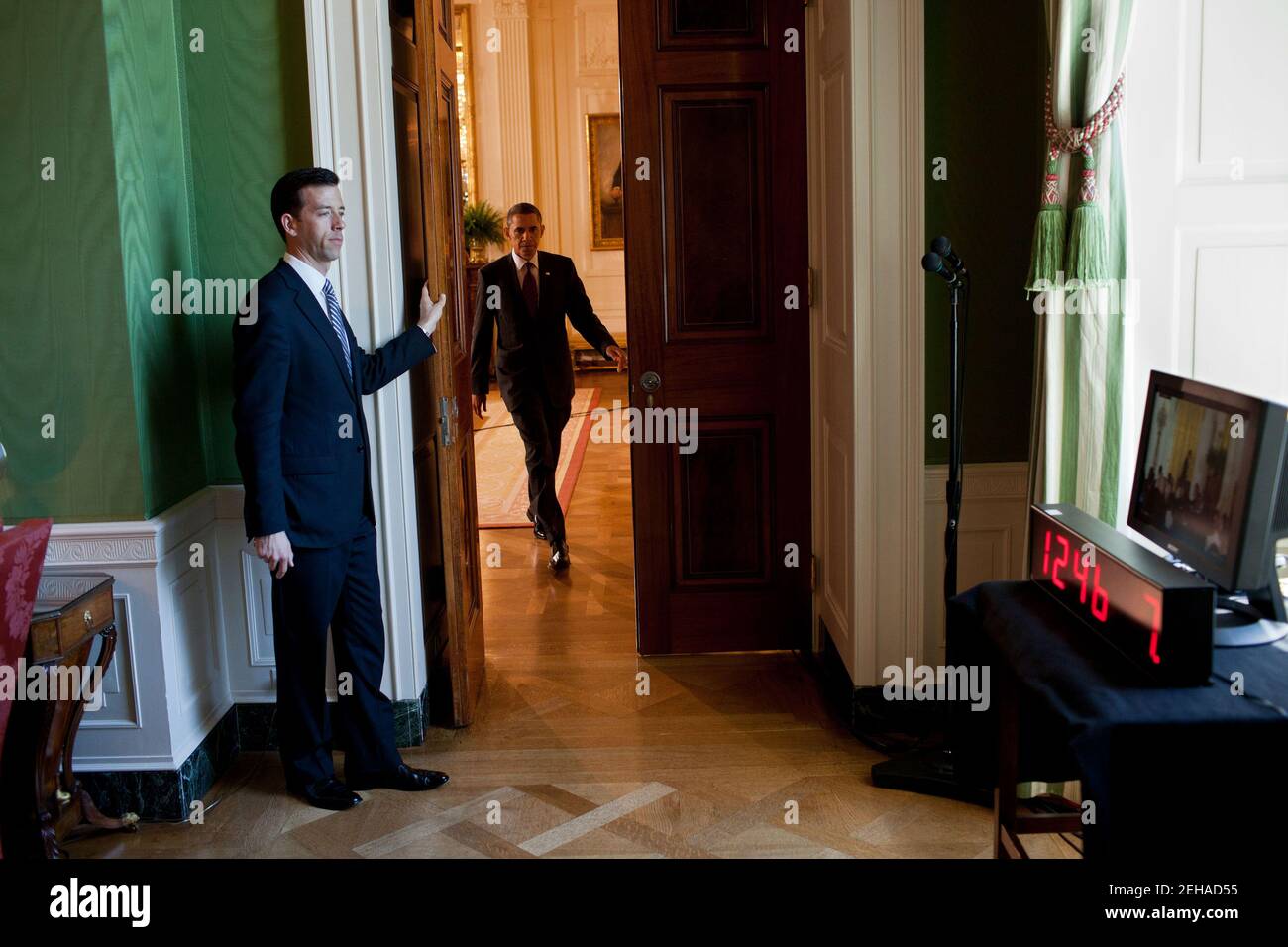 Brian Mosteller, Deputy Director of Oval Office Operations, holds the door for President Barack Obama in the Green Room of the White House following the President's East Room press conference, June 29, 2011. Stock Photo