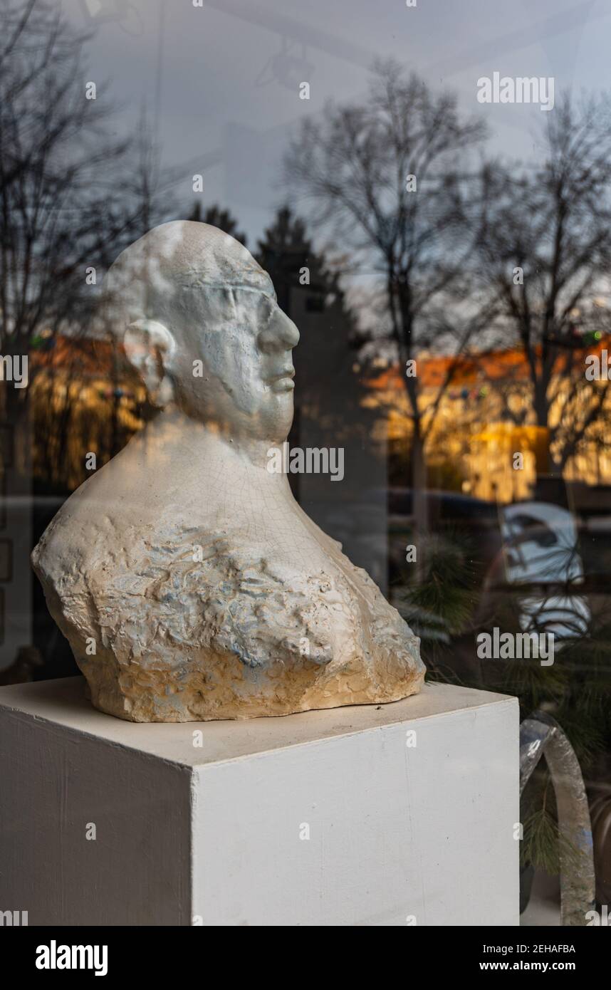 Wroclaw January 14 2020 Old statue behind window with reflections of park Stock Photo