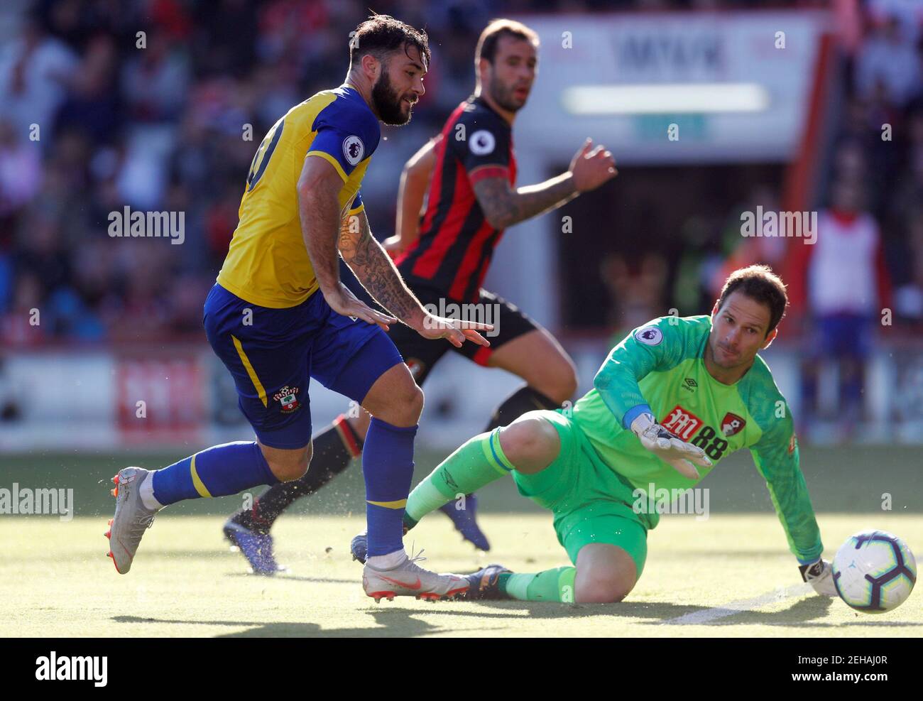 Soccer Football - Premier League - AFC Bournemouth v Southampton - Vitality Stadium, Bournemouth, Britain - October 20, 2018  Southampton's Charlie Austin in action with Bournemouth's Asmir Begovic   REUTERS/Eddie Keogh  EDITORIAL USE ONLY. No use with unauthorized audio, video, data, fixture lists, club/league logos or 'live' services. Online in-match use limited to 75 images, no video emulation. No use in betting, games or single club/league/player publications.  Please contact your account representative for further details. Stock Photo