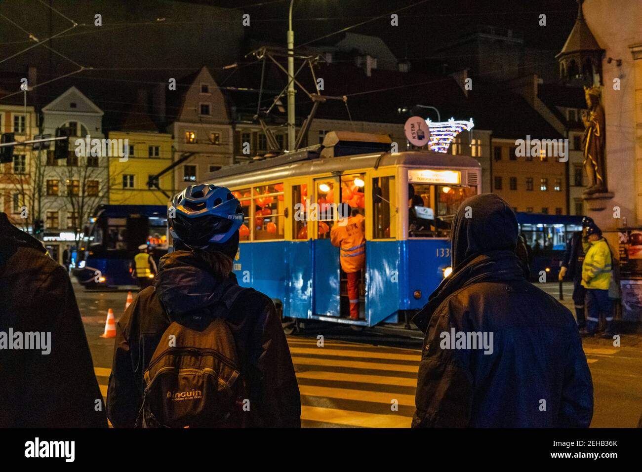 Wroclaw January 17 2020 People looking to Old Derailed tram on street at night Stock Photo