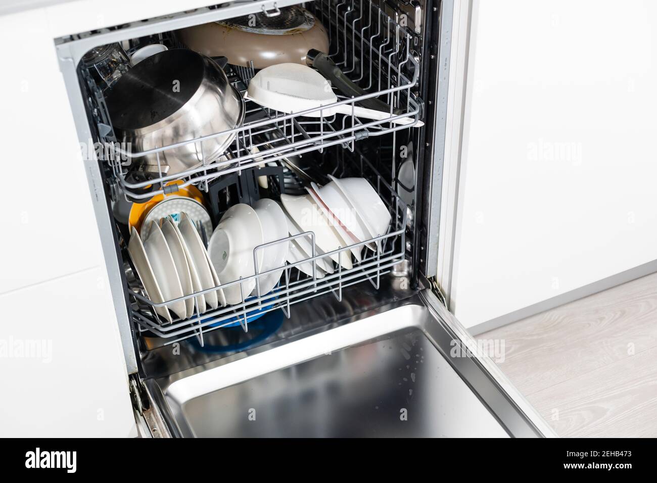 Modern dishwasher open, technology, kitchen. Stock Photo