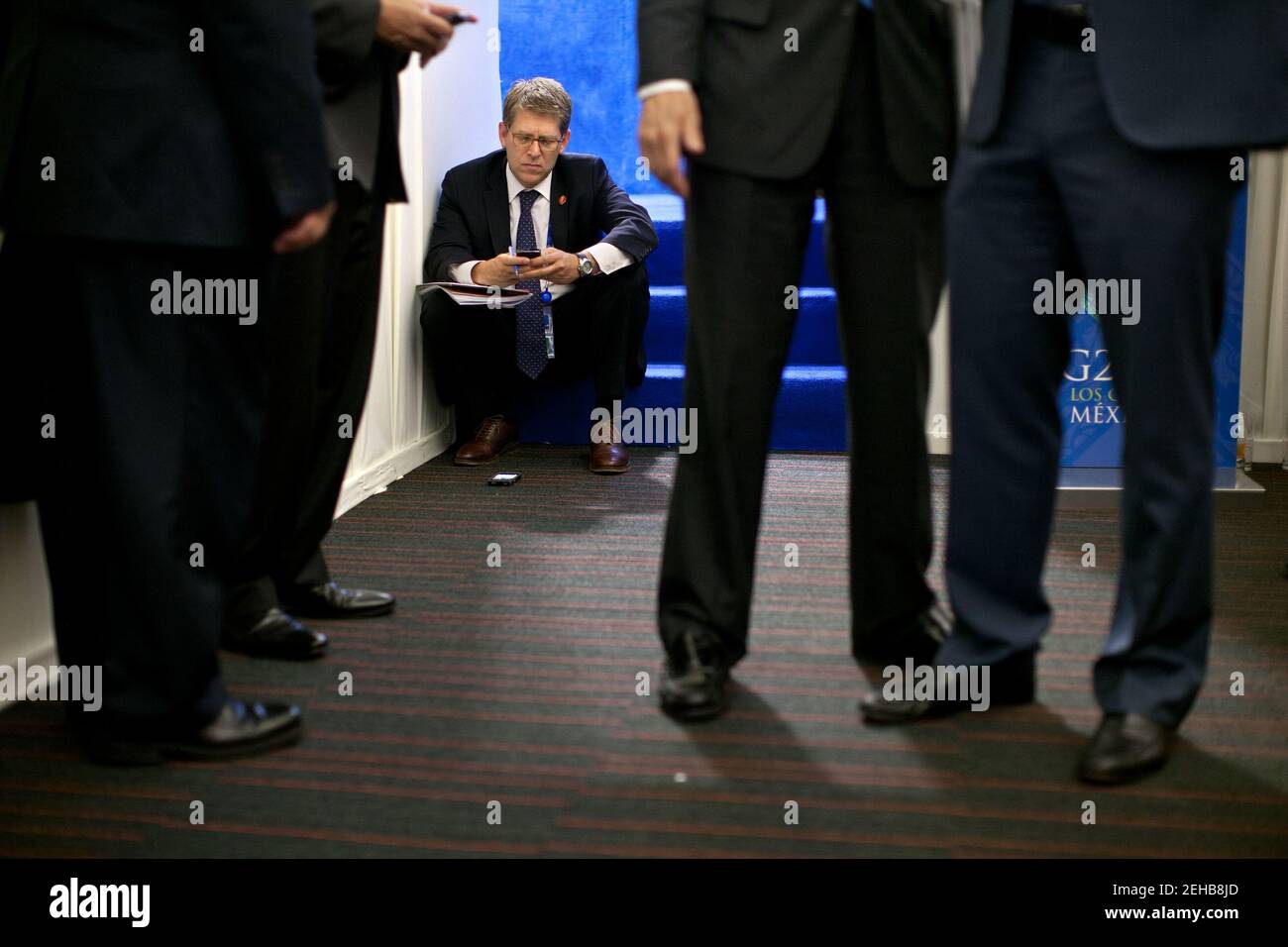 Press Secretary Jay Carney works on his BlackBerry as President Barack ...
