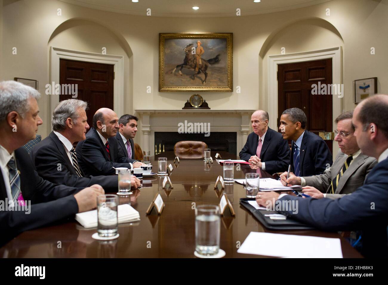 President Barack Obama drops by a meeting between National Security Advisor Tom Donilon and Deputy Prime Minister Shaul Mofaz of Israel, third from left, in the Roosevelt Room of the White House, June 21, 2012. Stock Photo