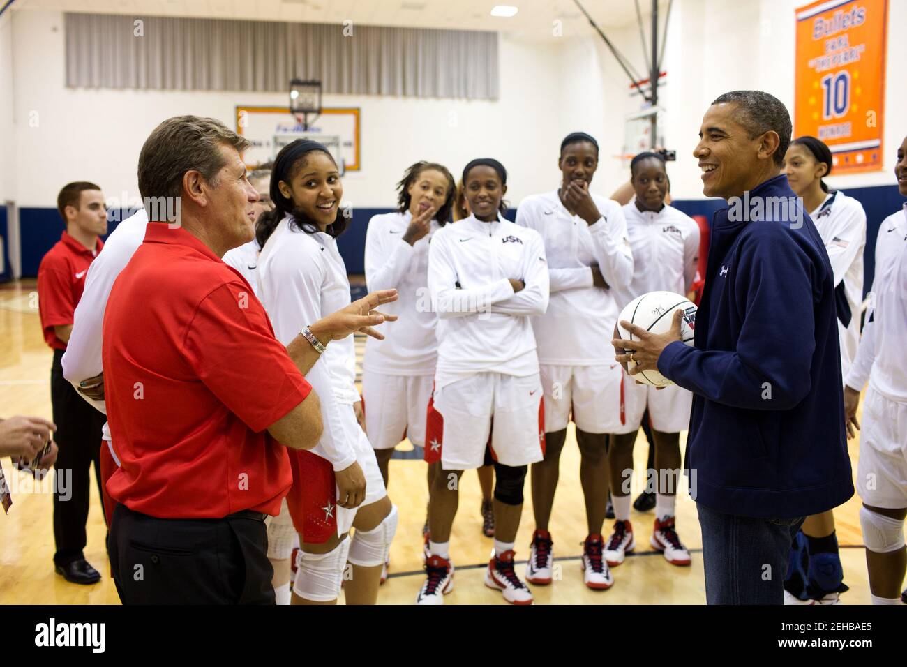 President Barack Obama talks with coach Geno Auriemma and members of the U.S. Women's Olympic basketball team following their 99-67 win over Brazil at the Verizon Center in Washington, D.C., July 16, 2012. Stock Photo