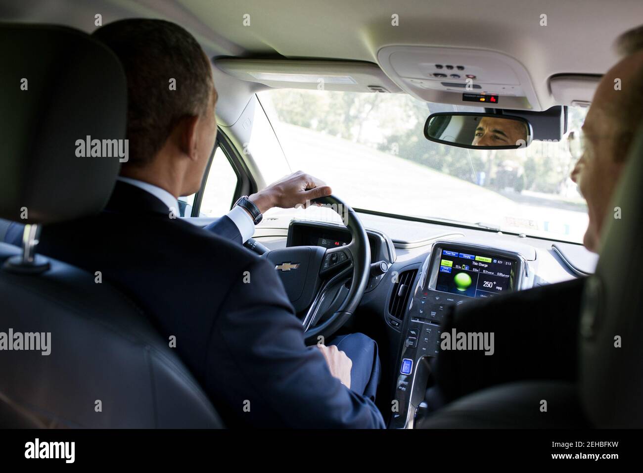 President Barack Obama drives former Press Secretary Robert Gibbs' Chevy Volt around the South Lawn Drive of the White House, Oct. 12, 2012. Stock Photo