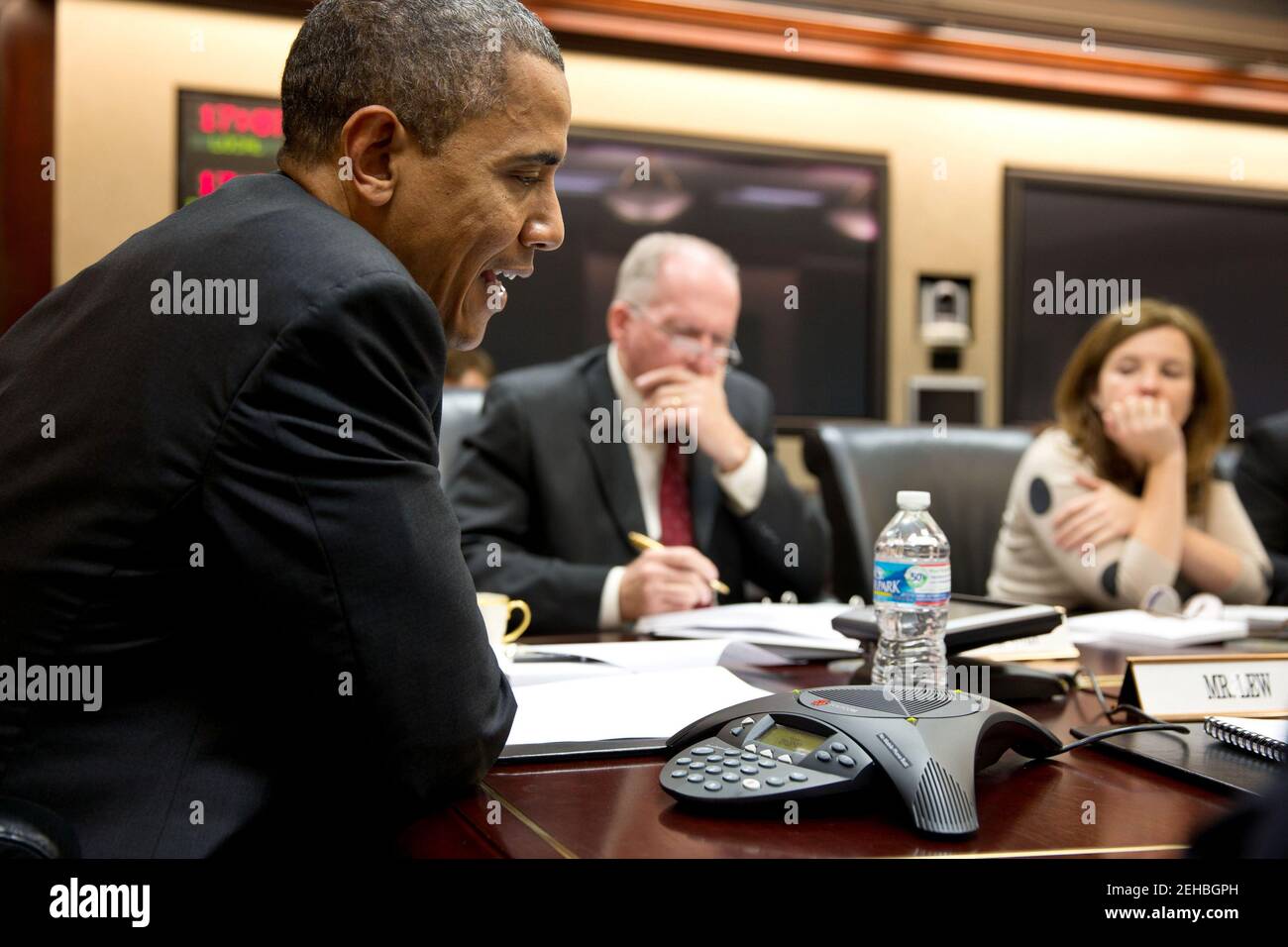 President Barack Obama participates in a conference call with electric utility executives to discuss the restoration of power for those who lost electricity during Hurrican Sandy, in the Situation Room of the White House, Oct. 30, 2012. John Brennan, Assistant to the President for Homeland Security and Counterterrorism, and Alyssa Mastromonaco, Deputy Chief of Staff for Ops, listen at right. Stock Photo