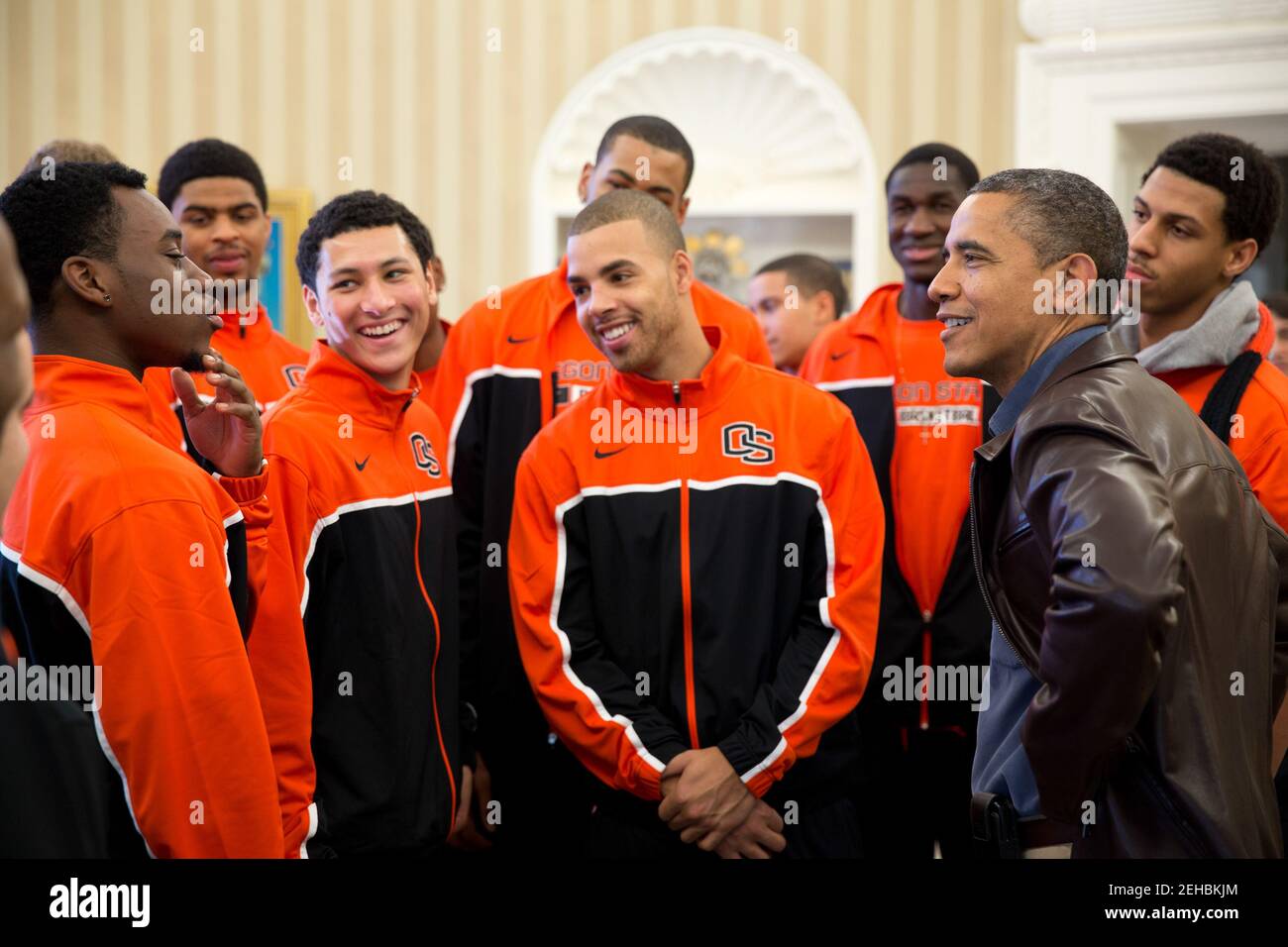 President Barack Obama jokes with players from the Oregon State University basketball team in the Oval Office on Thanksgiving Day, Nov. 22, 2012. The team's head coach is Craig Robinson, brother of First Lady Michelle Obama. Stock Photo