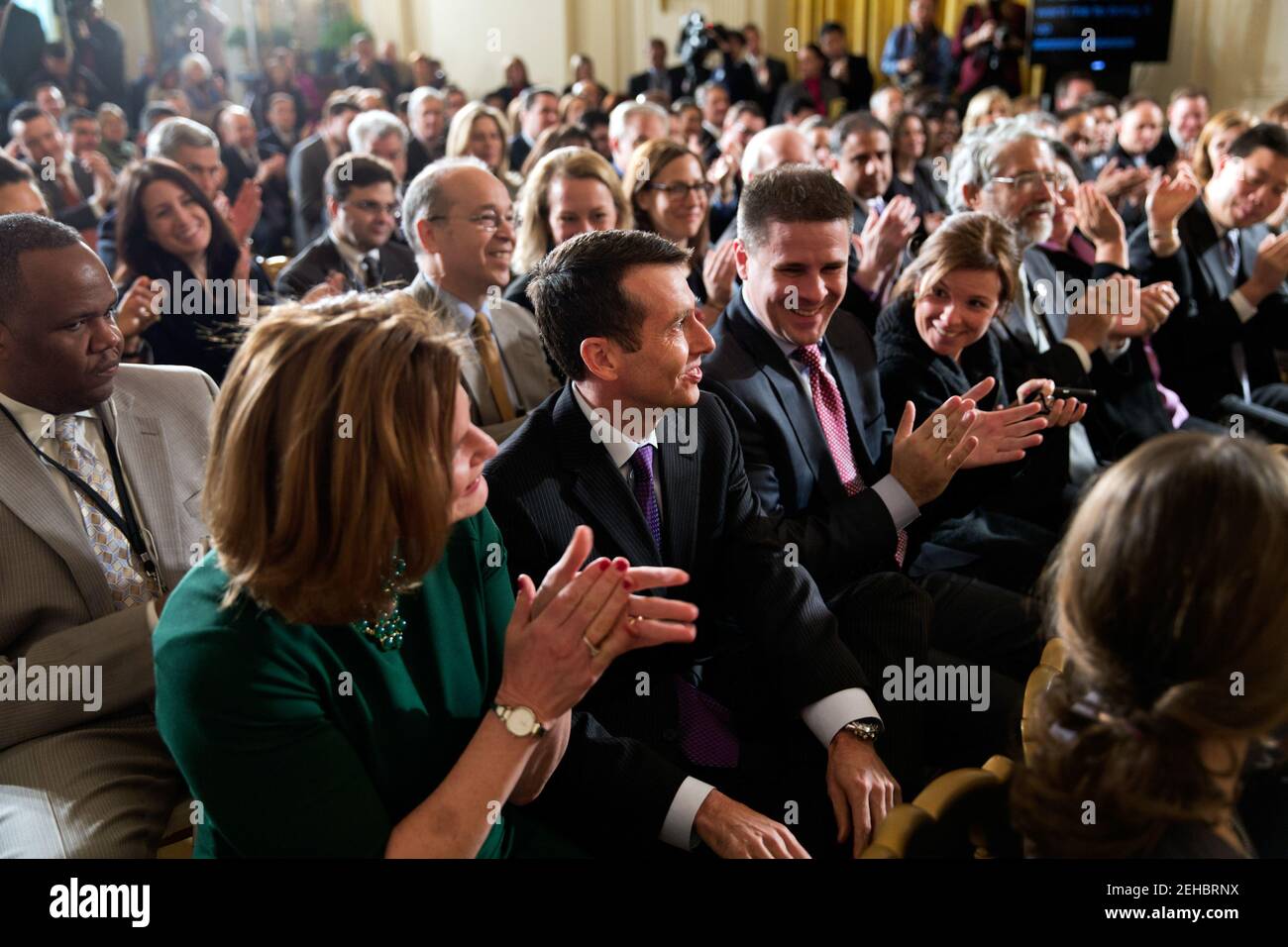 David Plouffe, second from left, receives applause as President Barack Obama thanks Plouffe for his service, during an event in the East Room of the White House, Jan. 25, 2013. Communications Director Jennifer Palmieri, left, Senior Advisor Dan Pfeiffer, and Alyssa Mastromonaco, Deputy Chief of Staff for Ops, are seated next to Plouffe. Stock Photo