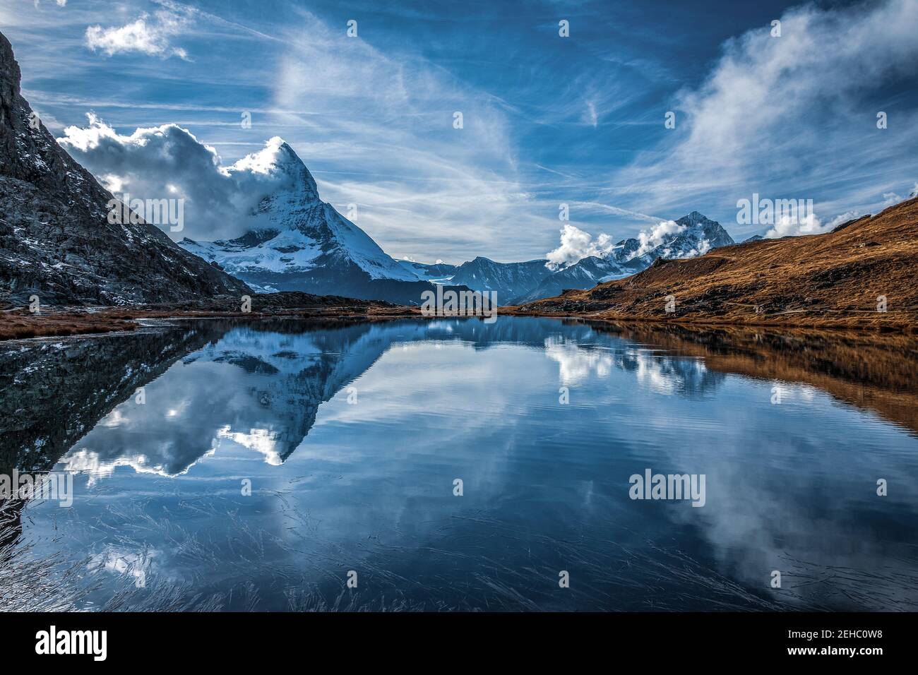 Panoramic view of Matterhorn peak, Switzerland. Matterhorn reflection in the Riffelsee. Stock Photo