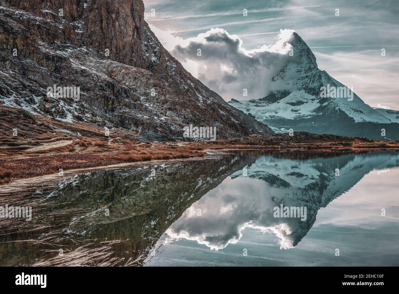 Panoramic view of Matterhorn peak, Switzerland. Matterhorn reflection in the Riffelsee. Stock Photo